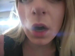 Blonde bitch smoking a cigarette in a close up video