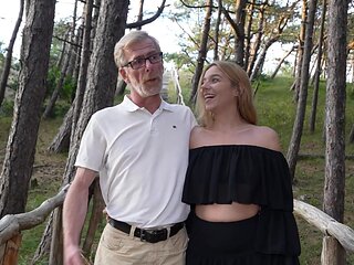 An old guy and a young girl are having sex in nature
