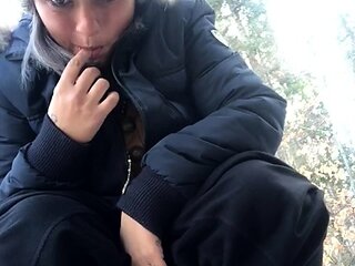 Outdoor solo masturbation scene with curly blonde