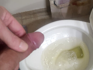 Playing with a pissing cock