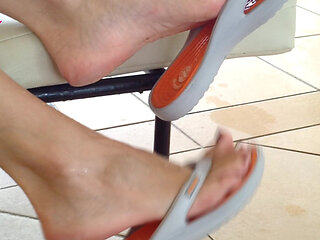 Dangling with Orange Flip Flops in a Swimming Pool