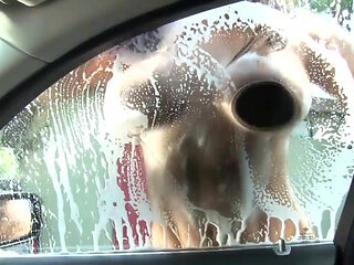 Sexy and wet girl washing car gives a good boobjob