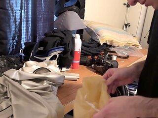 Bound in a shiny spandex trenchcoat with a latex head balloon for breathplay