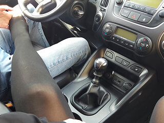 Stylish woman teases taxi driver in the car with her sexy legs