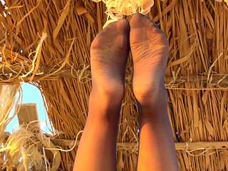 The Best View on the Beach Is Not the Sea, but My Feet in Black Tights Hanging Over Your Head