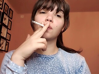 Big lips covered in lipgloss smoking with close up of the lips