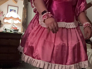 In a pink maid outfit for a day of being a servant