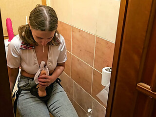 A girl fucks a guy in the ass in the toilet with a strap on