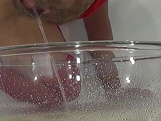 A MILF in Red Is Peeing Into a Basin.