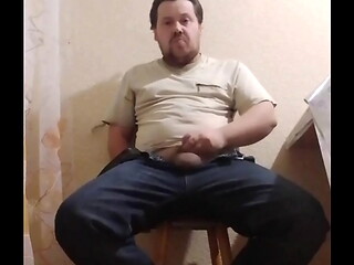A fat gay man sat down on a chair to masturbate his little cock