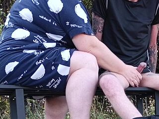 Stepmom in a public park fingering my dick on a bench