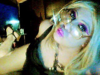 Sexy crossdresser Krissy Sweets in lingerie and high heels with fishnets.