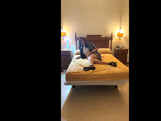 Beautiful Spanish trans girl poses seductively in the bedroom with a latex miniskirt and high heels.