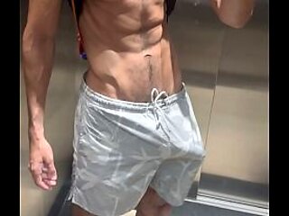 Huge hard cock in shorts without underwear in the elevator