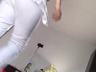 Amateur wife dancing naked at home. Amateur woman has fun trying on clothes and cutting them.