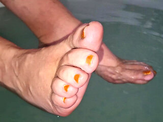 My girlfriends' cute wet feet teasing me in the hot tub