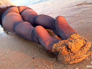 Sea Waves Gently Kiss the the Goddess Feet in Black Pantyhose at Sunset
