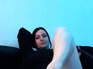 Brunette with foot fetish rubs big dick with her feet i...