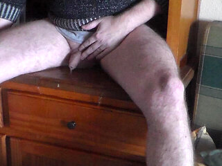 John is pissing all over the bookcase