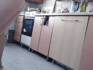 Sexy naked wife preparing food in the kitchen. Hairy brunette, big ass, big tits.