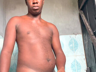 Nigerian guy strokes big dick at home