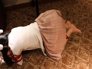 A Cute Little Dressed in a Jk Uniform Was Walking Around Barefoot on the Ground.
