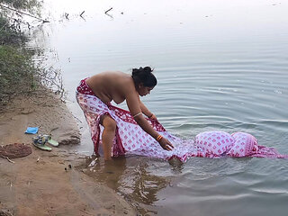 Indian village wife bathing in the river in outdoor area