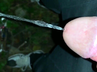 Slowmotion and Close up. Unwashed Uncut Cock Piss on the Ground Outdoor. Long Piss Stream