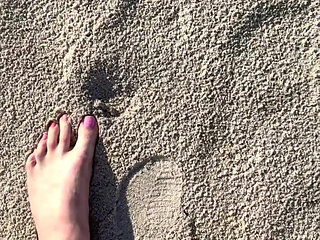 Comparing Size 16 Feet to Sand Prints at the Beach