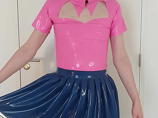 Putting on blue latex skirt over pink rubber maid dress and stockings, layers