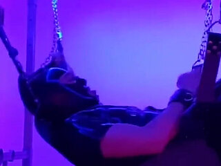 Rubber slave fucked in sling