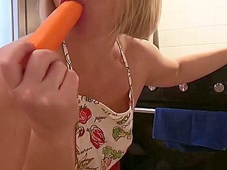 The blonde is excited in the kitchen and plays with veg...