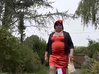 Dressed in a tight orange dress for an evening out