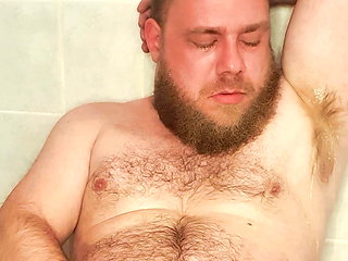 The gay pig's piss just sprays out of his hairy cock straight into his face