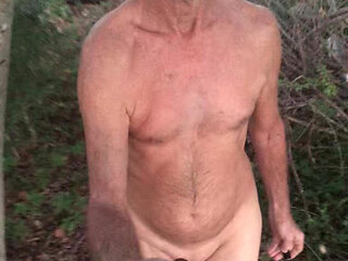 Behind my house in the woods walking around naked