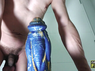 Practicing anal stretching with a  huge dildo