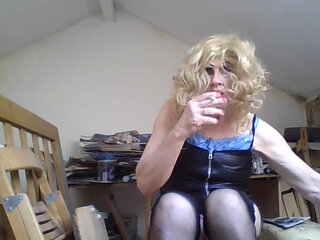 Femboi fag slut Sarah smokes and poses in a black latex dress, then removes it to show off her lingerie