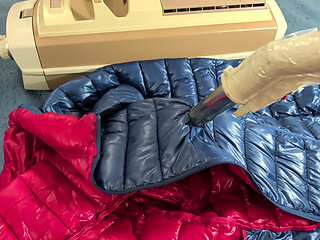 Vacuuming girlfriend's light down jacket with vintage electrolux