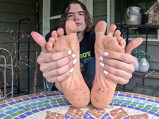 Boy shows off his dirty soles