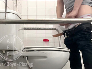 In the Hospital Toilets, a Guy Pisses Into a Cup for a Urine Sample, Then Gets Horny, Jerks-off and Cums