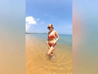 A sexy girl Lovita Fate playing on the beach in a bikini