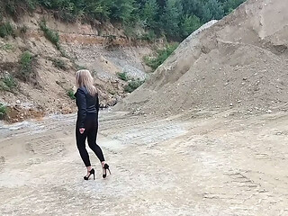 Grandma is walking around a gravel pit in tight leggings and high heels!