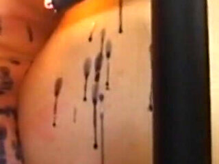 Humiliating wax play in the cage