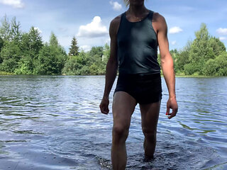 Trans girl Alexa Cosmic swimming and playing in the lake wearing black short and blue top