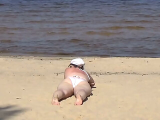 Nimble mature mommy has fun with young guys on the beach 2