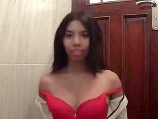 Sexy brunette Asian babe fools around with the camera