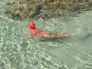 Pink bikini in a beautiful bay