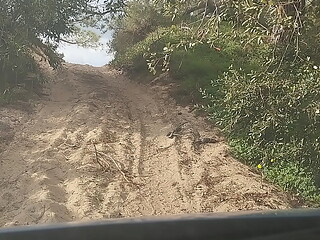 Guy of car spills a lot of milk on a trail near the sea