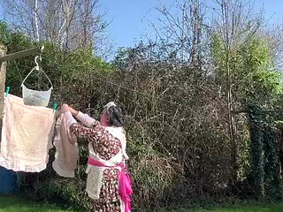 In maid gardener outfit to hang the laundry