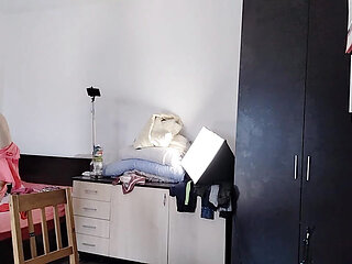 The sexy wife is having fun testing clothes and cuts them. The brunette dances naked around the house.